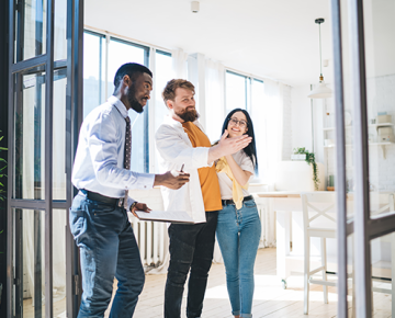 couple looking at house with real estate agent