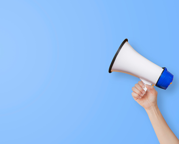 arm holding megaphone against blue background