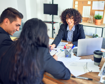woman reviewing paperwork with couple