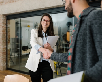 woman shaking man's hand in the office