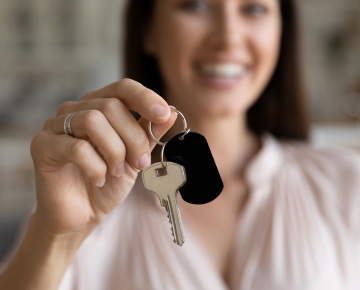 woman holding key in front of her